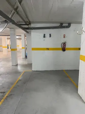 an empty parking garage with yellow and white walls at Quarteira Panoramic View by Homing in Quarteira