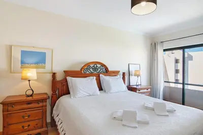 a bedroom with a bed with two white towels on it at Casa dos Salgados in Albufeira