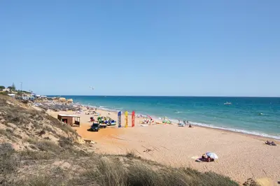 a beach with a lot of people and the ocean at Casa dos Salgados in Albufeira