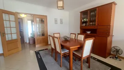 a dining room with a wooden table and chairs at Casa Old Town Splendida in Albufeira