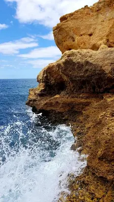 a rocky cliff next to the ocean at Casa Old Town Splendida in Albufeira