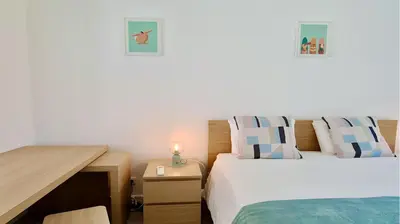 a bedroom with two beds and a wooden desk at Marina Algarve-CleverDetails, located on the marina close to all main amenities in Vilamoura