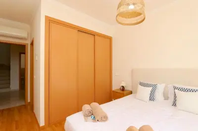 a bedroom with two beds and a large closet at Villa Bolivia-CleverDetails in Vilamoura