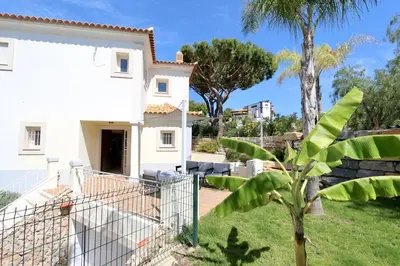a white house with a palm tree in the yard at Villa Bolivia-CleverDetails in Vilamoura