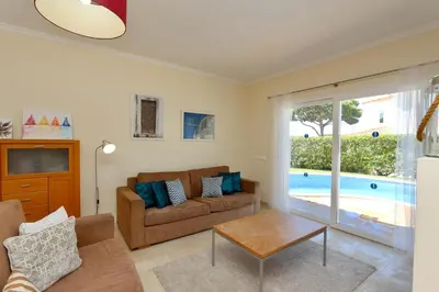 a living room with a couch and a table at Villa Bolivia-CleverDetails in Vilamoura