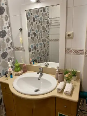 a bathroom with a white sink and a shower at Guesthouse Milagre Centro Faro in Faro