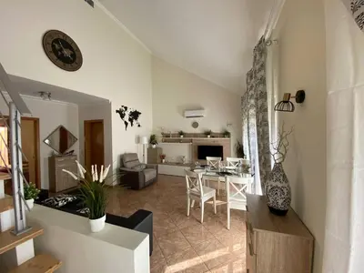 a living room with a table and a dining room at Guesthouse Milagre Centro Faro in Faro