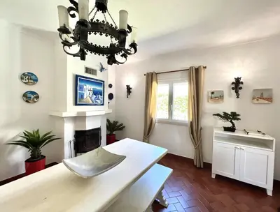 a living room with a chandelier and a fireplace at Vila Rose - Private Pool by HD PROPERTIES in Vilamoura