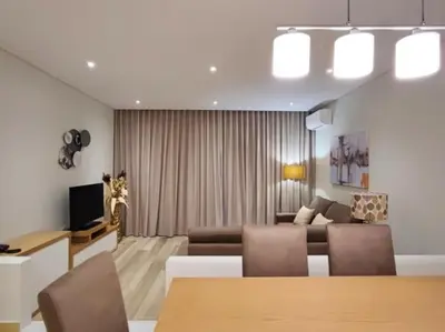 a living room with a couch and a table and chairs at Albufeira Sol Villas III by Stay ici Algarve Holiday Rental in Albufeira