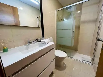 a bathroom with a toilet and a sink and a shower at Mar e Sol by - T3 , wi-fi e estacionamento in Quarteira