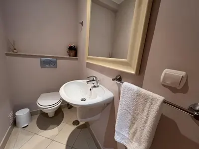 a bathroom with a sink and a toilet and a mirror at Victoria I - Vasco da Gama by HD PROPERTIES in Vilamoura