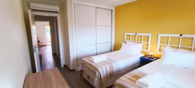 a bedroom with two beds and a yellow wall at Blue & Yellow Penthouse with Terrace at Balaia Mar in Albufeira