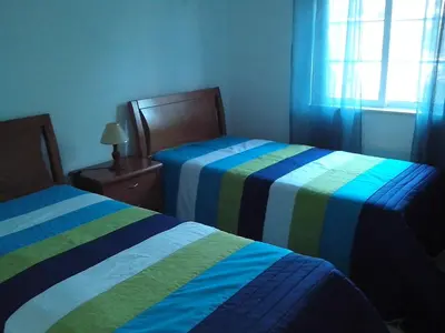 a bedroom with two beds with striped sheets at Charming 2-Bed Apartment in Olhos de Agua in Albufeira