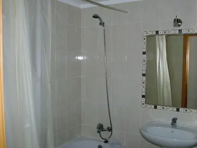 a bathroom with a shower and a sink and a mirror at Stunning 1-Bed Apartment in Olhos de Agua in Albufeira