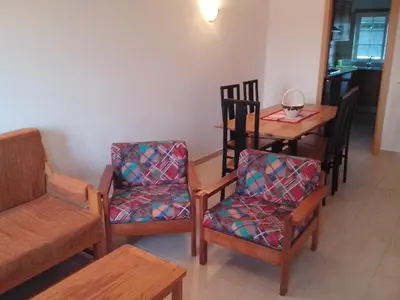 a room with a table and chairs and a dining room at 2 Bed Flat - Sleeps 4 - Parking - Wifi in Albufeira
