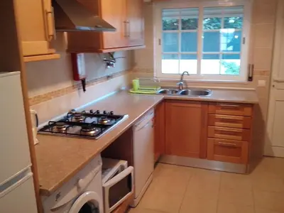 a kitchen with a stove top oven next to a sink at 2 Bed Flat - Sleeps 4 - Parking - Wifi in Albufeira