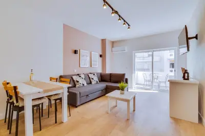 a living room with a couch and a table at AL - Apartamento Pontemira in Quarteira