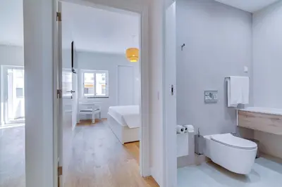 a white bathroom with a toilet and a sink at AL - Apartamento Pontemira in Quarteira
