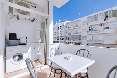 a white apartment with a white table and chairs at AL - Apartamento Pontemira in Quarteira