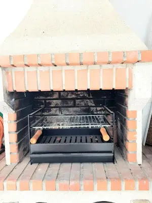 a brick oven with two hot dogs in it at Alojamento local 