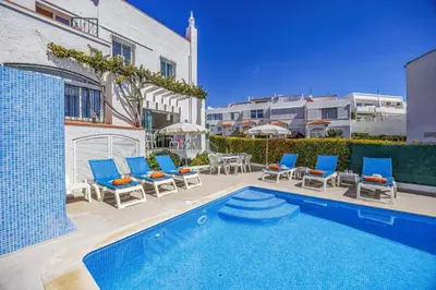 a bathroom with a shower and a toilet and a sink at Villa Alegre by Villa Plus in Albufeira