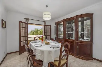 a dining room with a table and some chairs at Villa Campos by Villa Plus in Guia