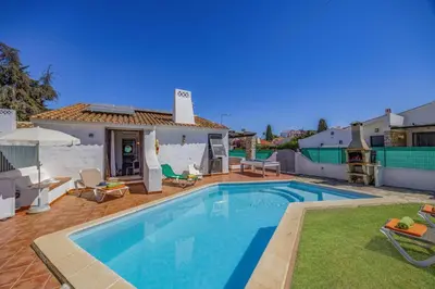 a swimming pool in the backyard of a house at Villa Sunshine by Villa Plus in Albufeira