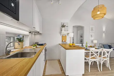 a kitchen with a sink and a counter top at Villa Lela by Villa Plus in Albufeira