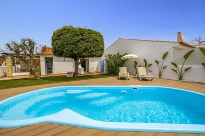a swimming pool in the yard of a house at Villa Lela by Villa Plus in Albufeira