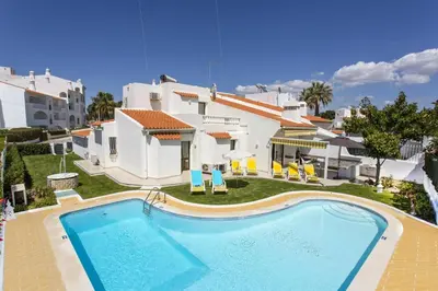 a swimming pool in front of a house at Villa Verao Sol by Villa Plus in Albufeira