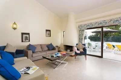 a living room with a couch and a table at Villa Verao Sol by Villa Plus in Albufeira