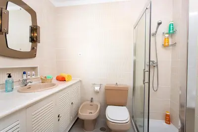 a bathroom with a toilet and a sink and a shower at Villa Verao Sol by Villa Plus in Albufeira