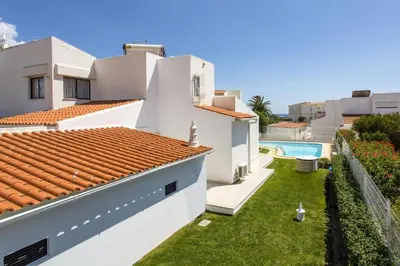 a view of a house with a yard and a swimming pool at Villa Verao Sol by Villa Plus in Albufeira