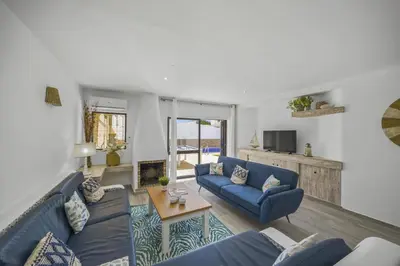 a living room with blue couches and a table at Villa Pina by Villa Plus in Albufeira