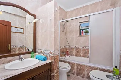 a bathroom with a sink and a toilet and a shower at Villa Boavista by Villa Plus in Boliqueime