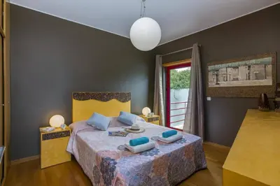 a bedroom with a bed with blue pillows on it at Villa Marina View by Villa Plus in Albufeira