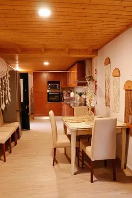 a kitchen and dining room with a table and chairs at Casa Rústica em Alte - KARMEA HOUSES in Alte
