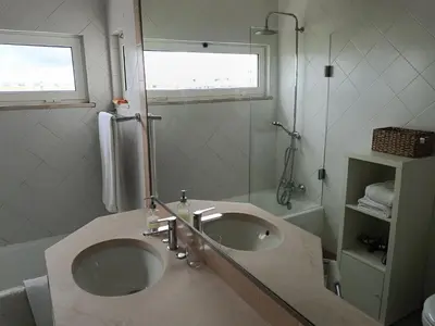 a bathroom with a sink and a shower at Apartamento 90m2 com vista mar - Albufeira in Albufeira