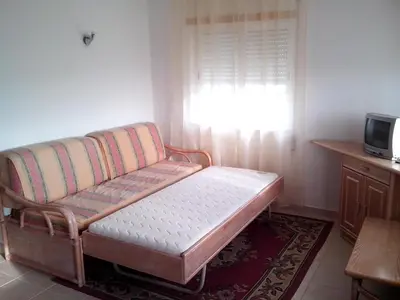 a living room with a couch and a window at Remarkable 1-Bed Apartment in Olhos de Agua in Albufeira