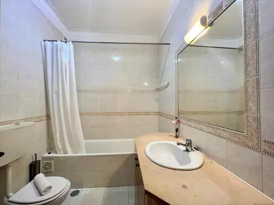a bathroom with a sink and a bath tub at Albufeira Classic 1 With Pool by Homing in Albufeira