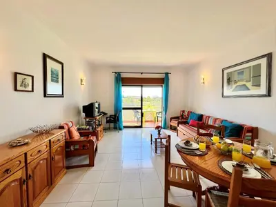 a living room with a table and a couch at Albufeira Classic 1 With Pool by Homing in Albufeira