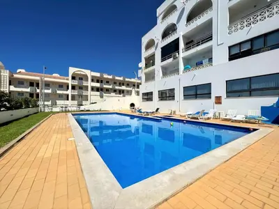 a swimming pool in front of a building at Albufeira Classic 1 With Pool by Homing in Albufeira