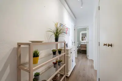 a hallway with shelves with potted plants on them at Ténis Mar F in Albufeira
