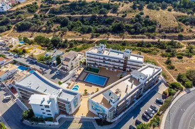 an aerial view of a building with a swimming pool at Solário de São José - AD by HelloVacations in Albufeira