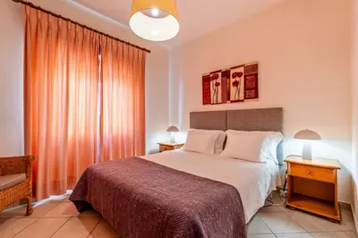 a bedroom with a large bed and a window at Ténis Mar E in Albufeira