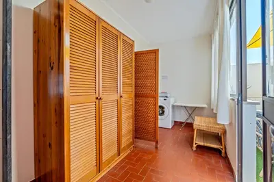 a hallway with wooden doors in a house at Ténis Mar E in Albufeira