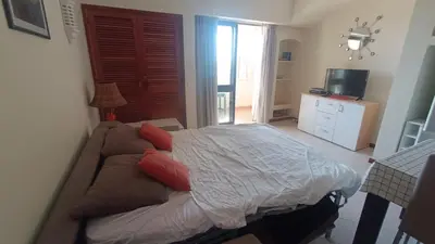 a bedroom with a bed with red pillows on it at Apartamento Bela Vista Tennis Club, FREE WIFI - By Algarkasa in Albufeira