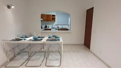 a kitchen with a table and chairs in a room at BeGuest Areias Apartment in Albufeira