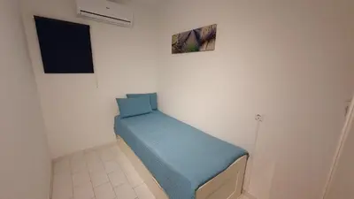 a small room with a blue bed on the wall at BeGuest Areias Apartment in Albufeira