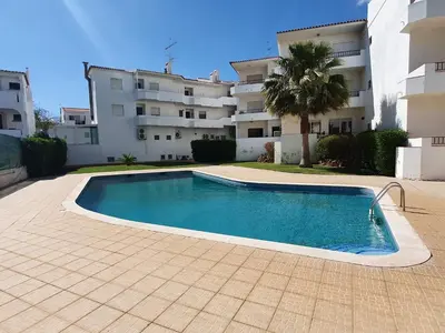 a swimming pool in front of a building at BeGuest Areias Apartment in Albufeira